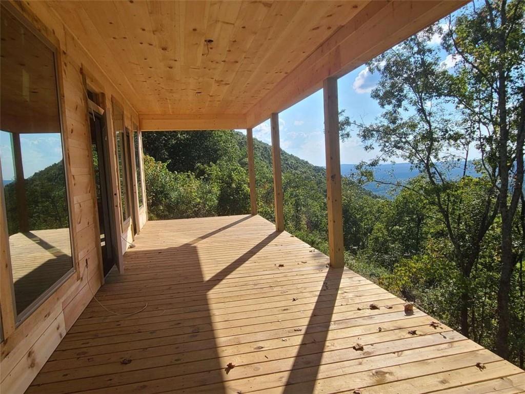 a view of balcony with wooden floor and fence