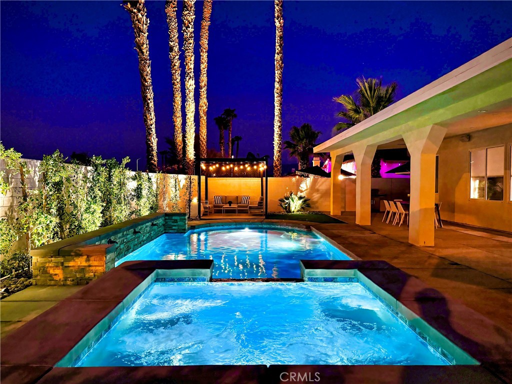 a view of a swimming pool with an outdoor seating