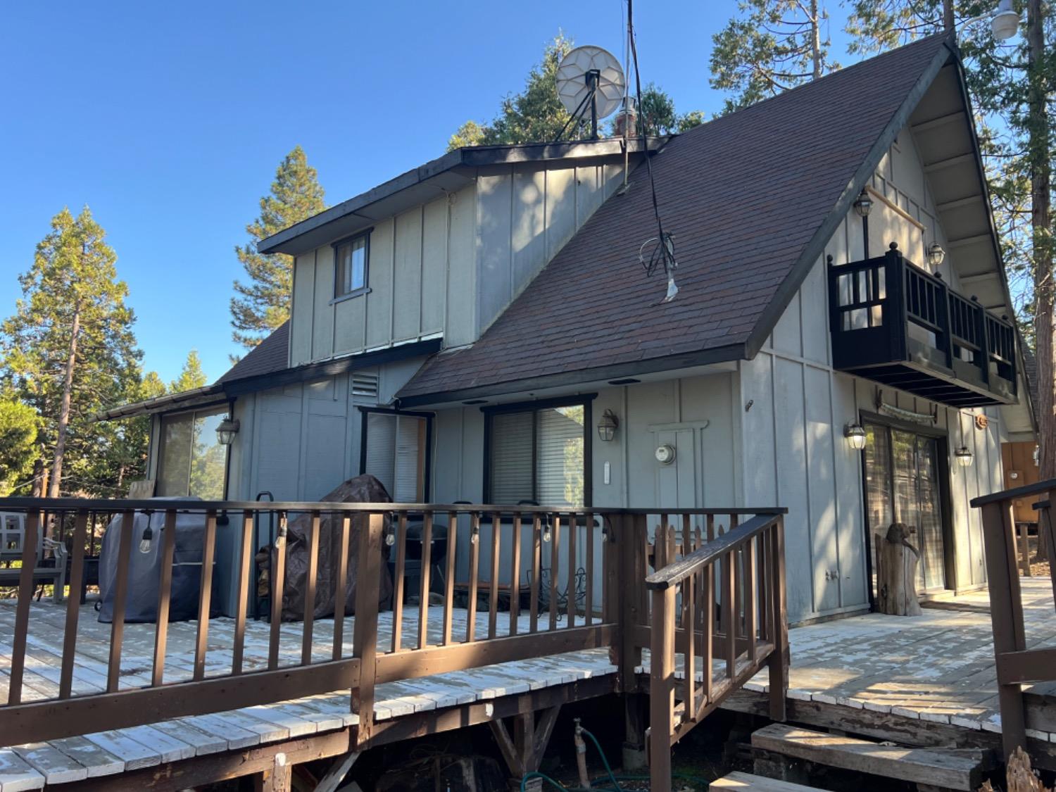 a view of a house with wooden deck