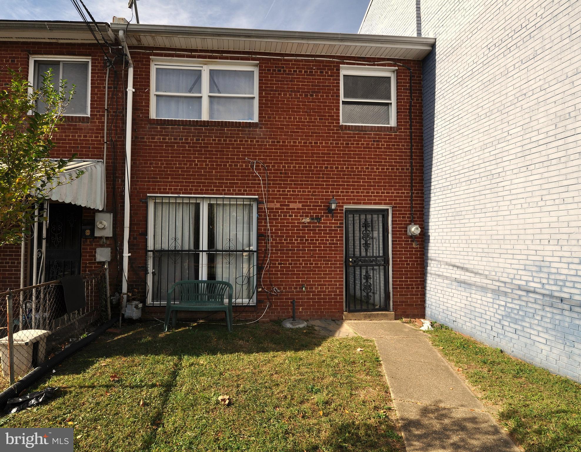 a view of a brick house with a large windows and a yard