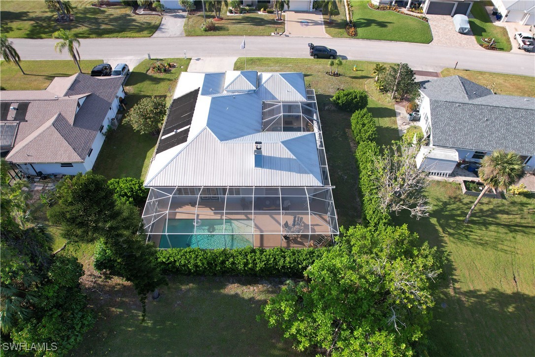 an aerial view of residential houses with outdoor space and lake view