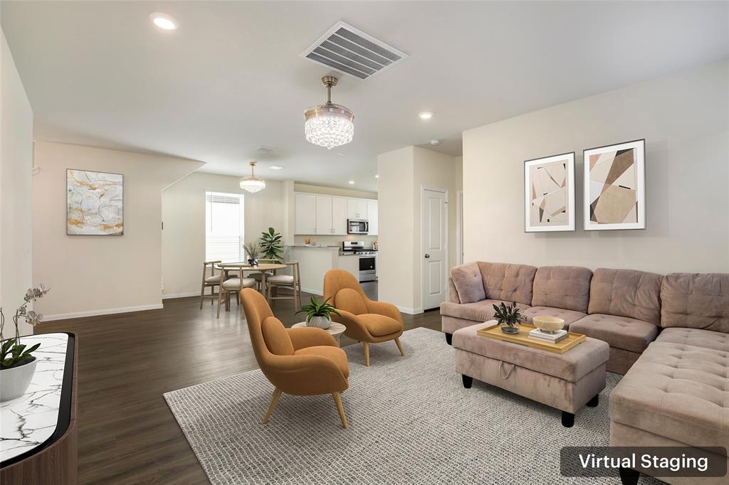 a living room with furniture kitchen and a table