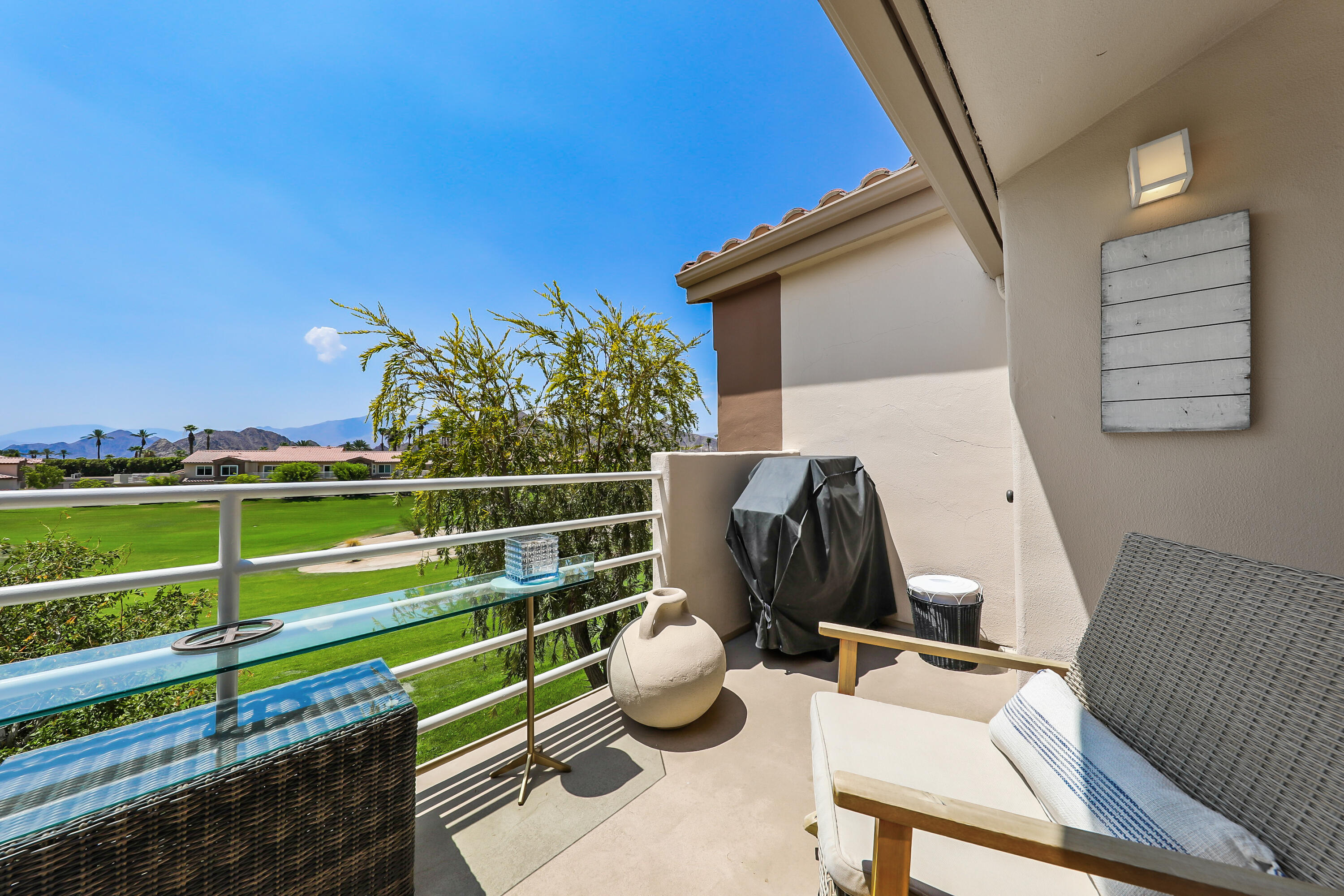 a view of a chair and tables back yard of the house