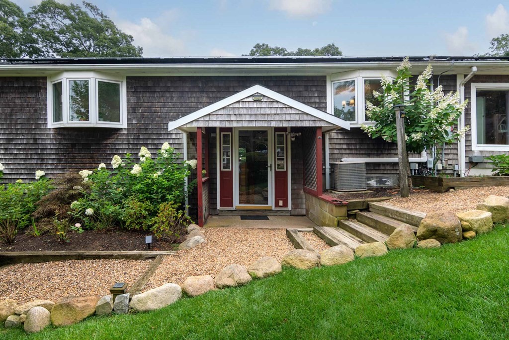 a view of a house with backyard porch and sitting area