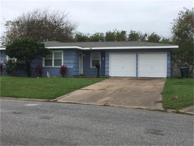 front view of a house with a yard and a garage