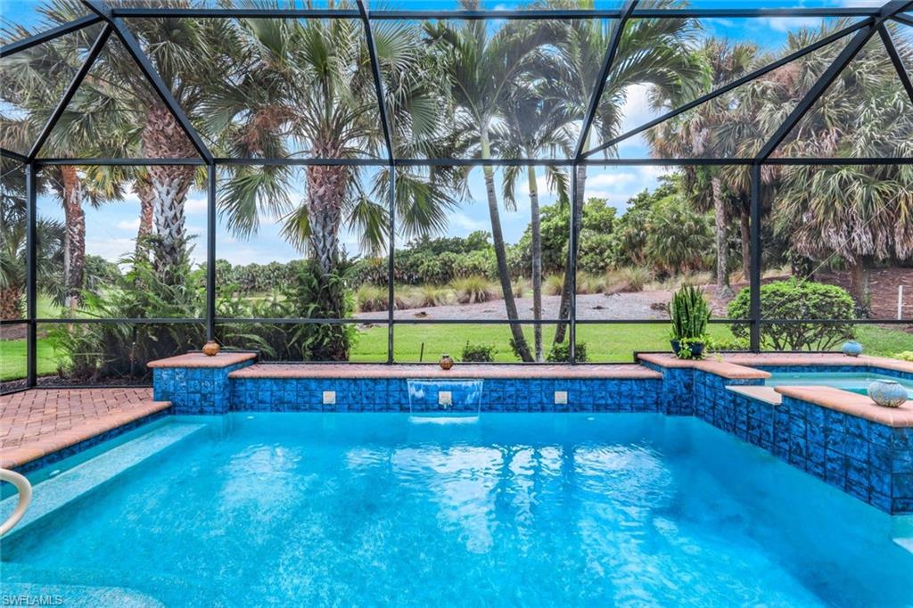 View of swimming pool and in ground hot tub