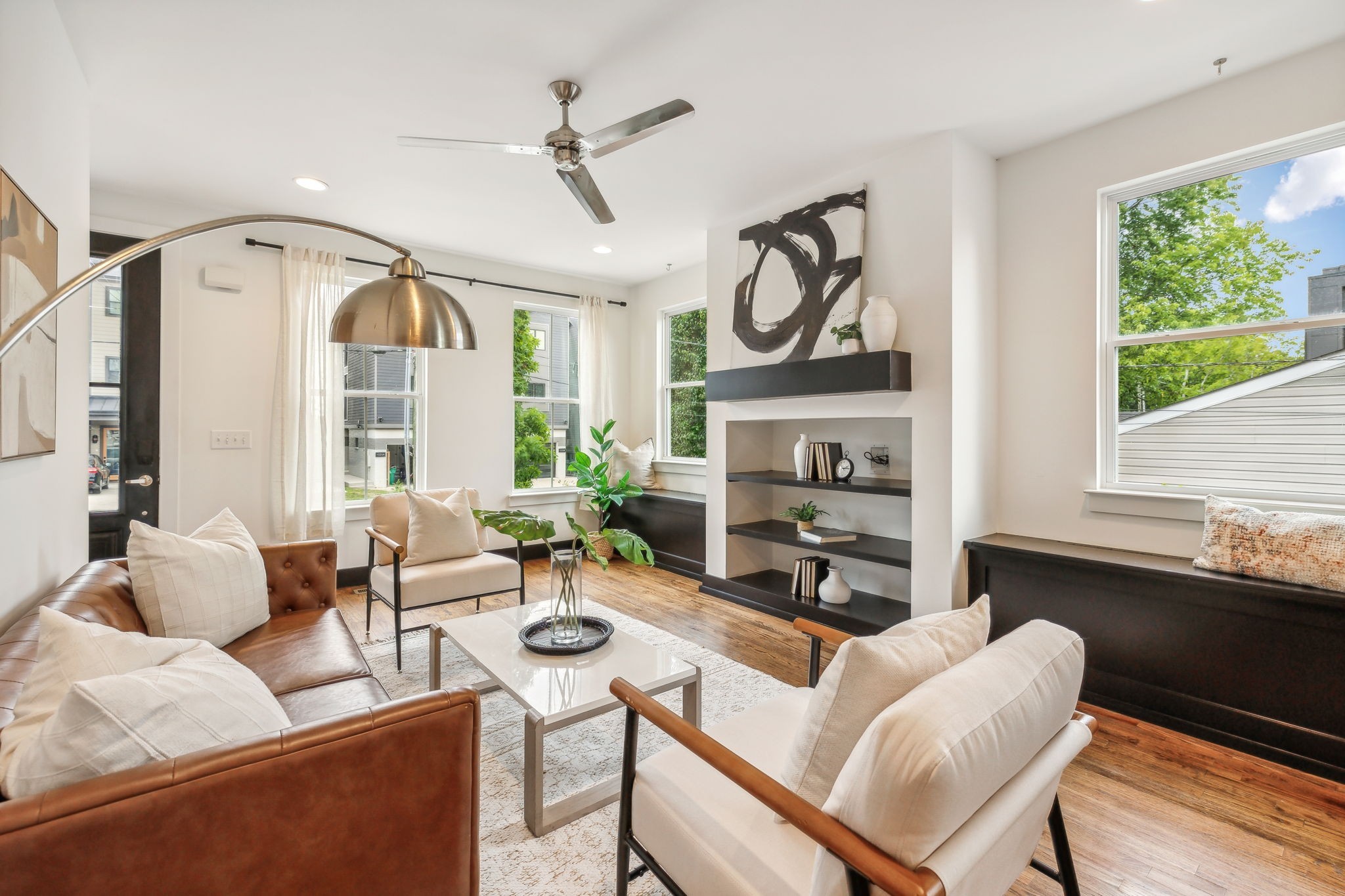 Gorgeous living room with built in shelves and bench storage under each window.