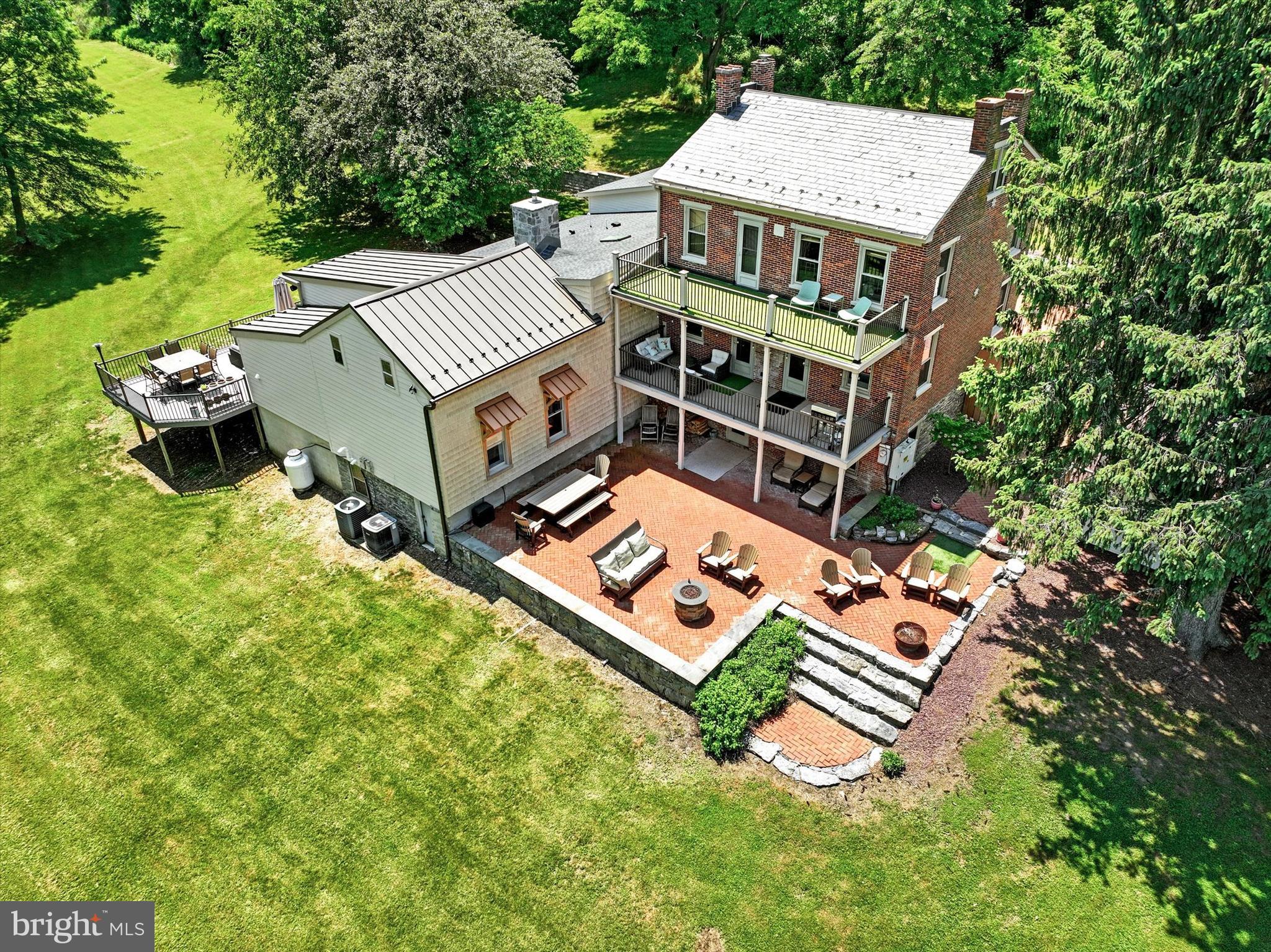 an aerial view of a house with a big yard and large trees