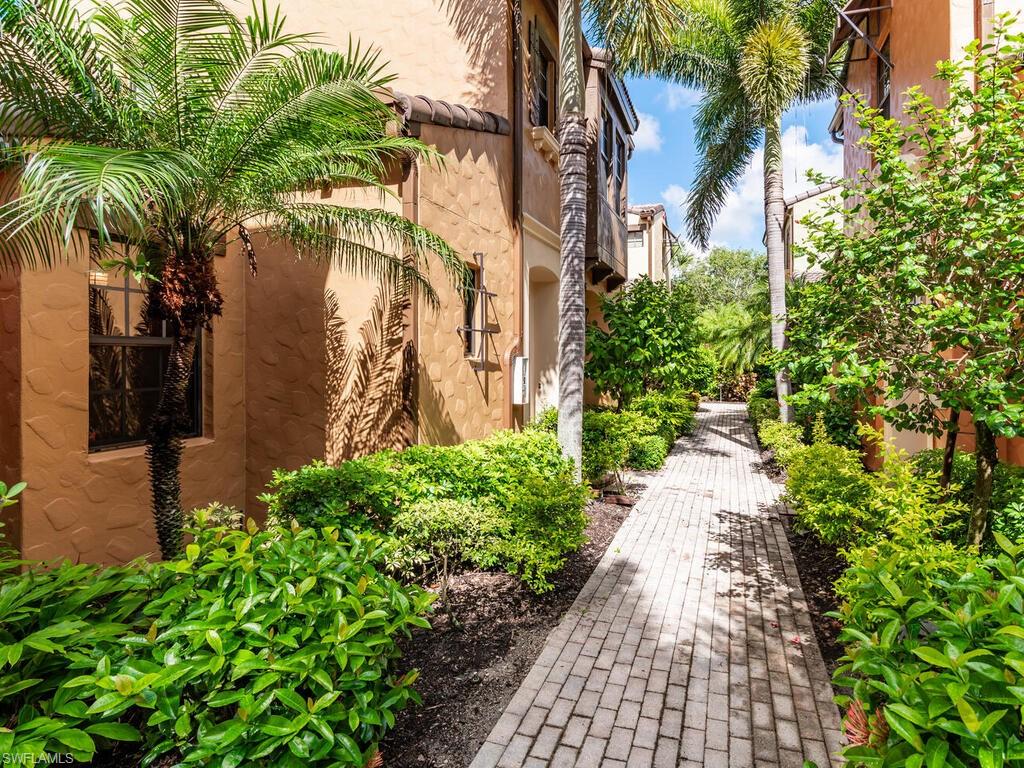 a view of a pathway both side of house