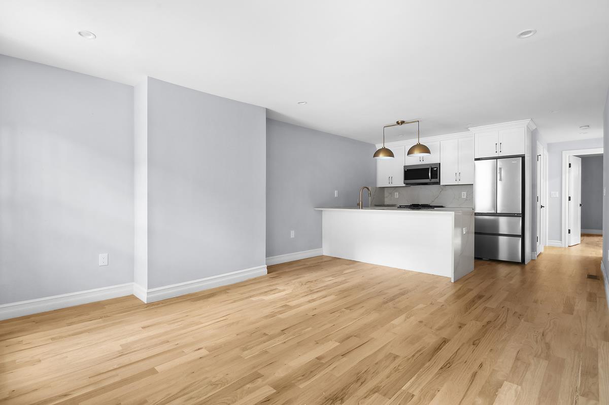 a view of a kitchen with wooden floor