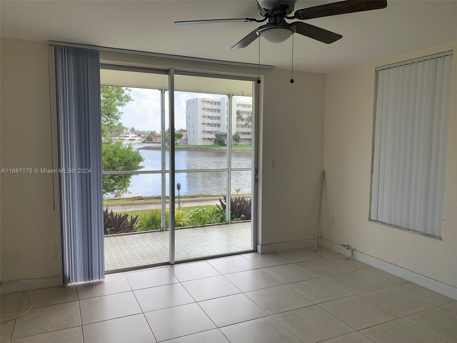 a view of a livingroom with a ceiling fan and window