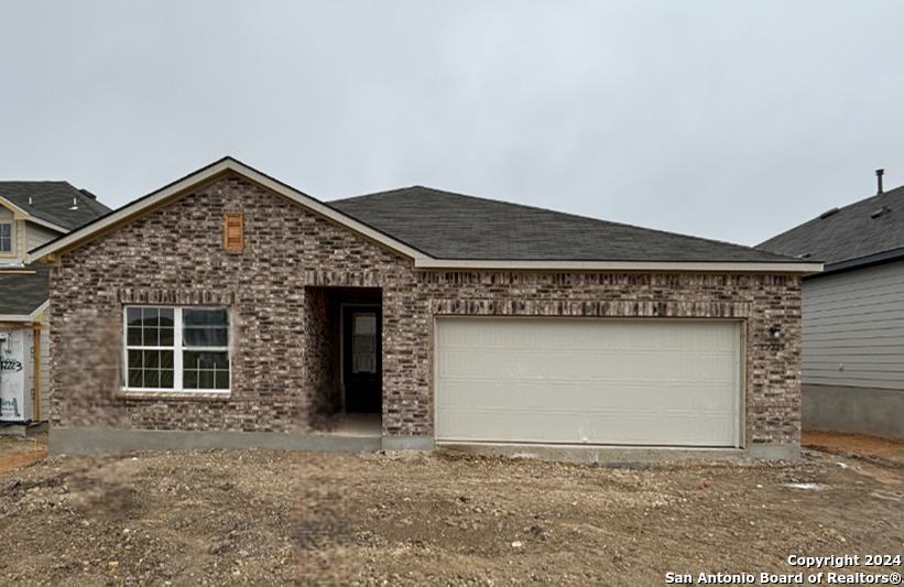 a front view of a house with garage