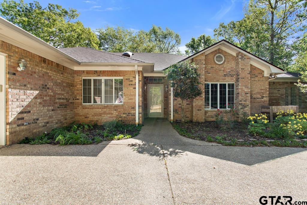 a front view of a house with a yard and trees