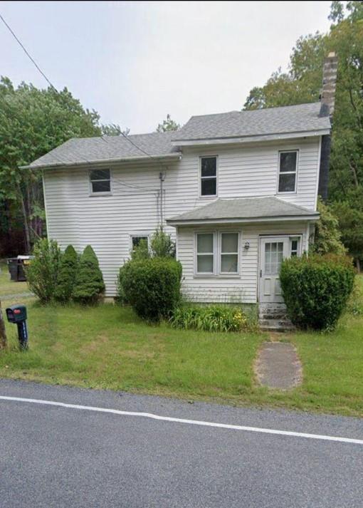 a front view of a house with a garden