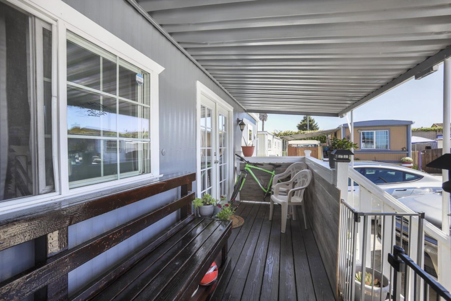 a view of a deck with table and chairs with wooden floor