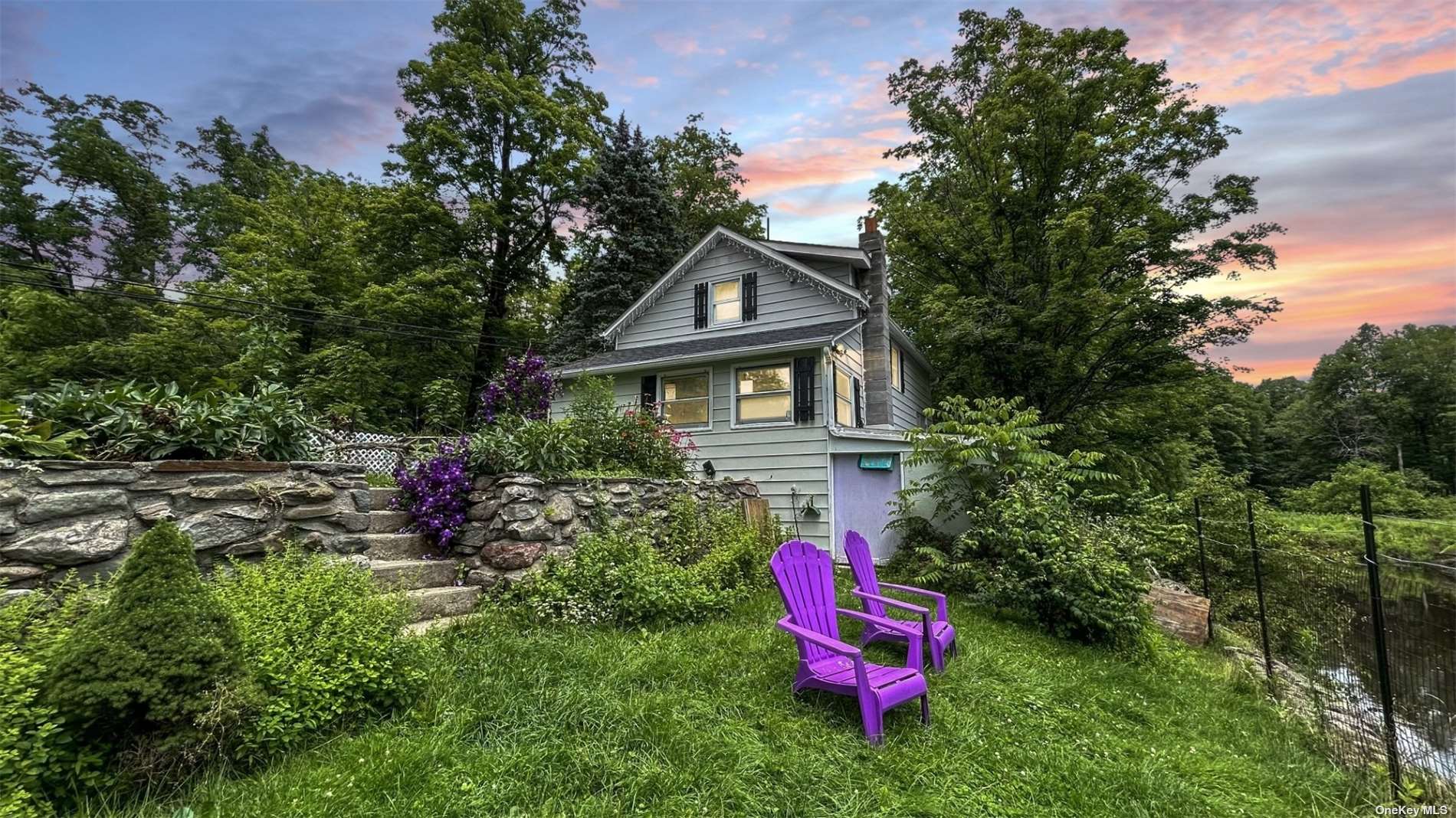 a front view of a house with a yard and sitting area