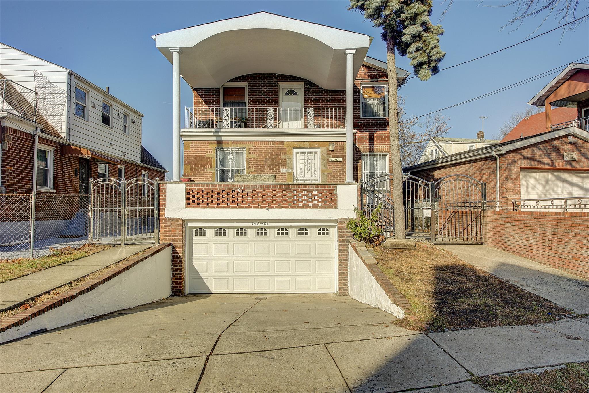 View of front of home with a balcony and a garage