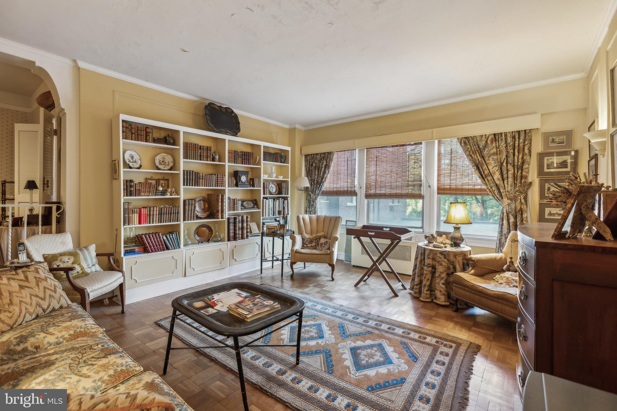 a living room with furniture and a floor to ceiling window