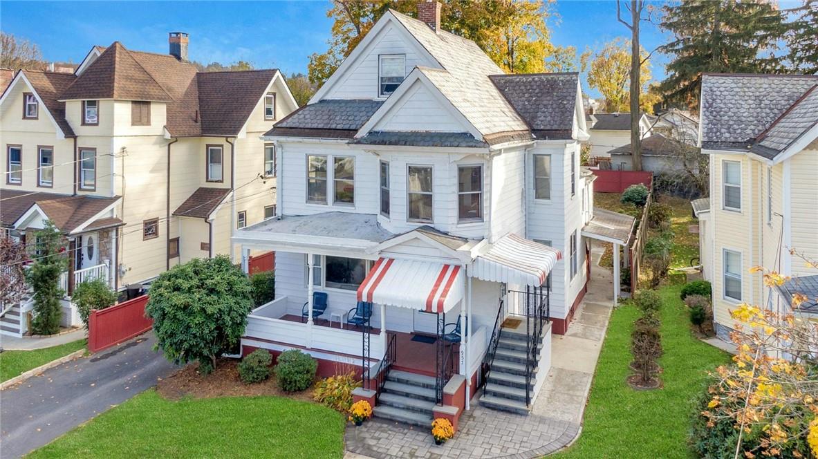 a aerial view of a house with a yard porch and furniture