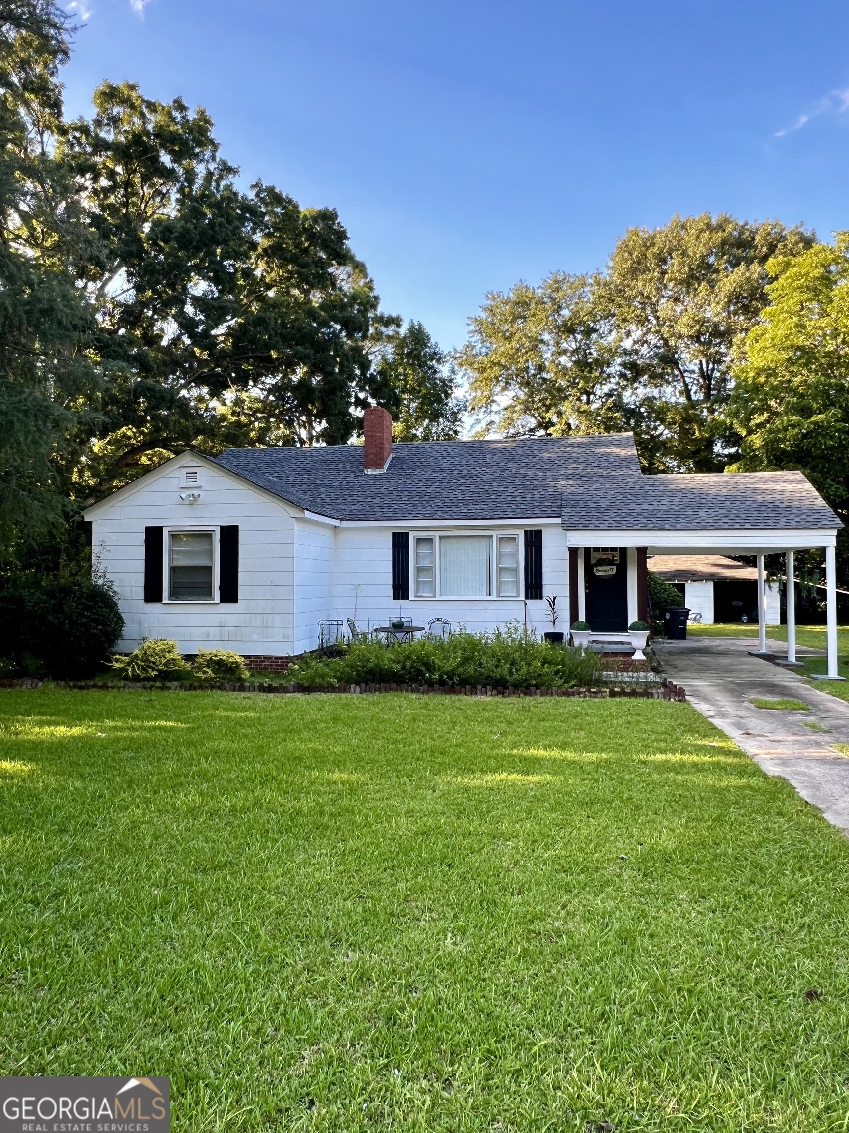 a front view of a house with a garden