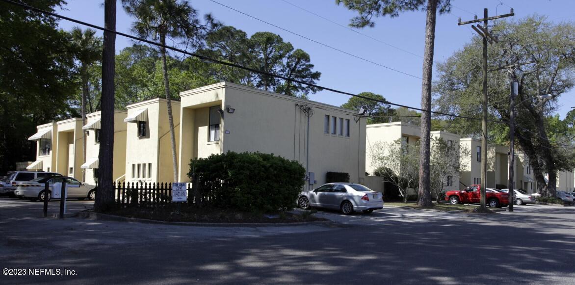 a view of a building with car parked