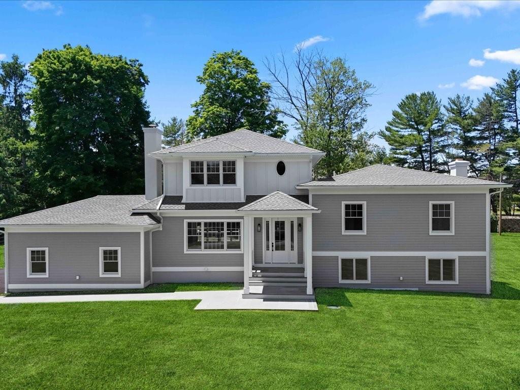 a front view of a house with a garden