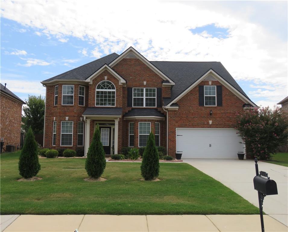 a front view of a house with a yard