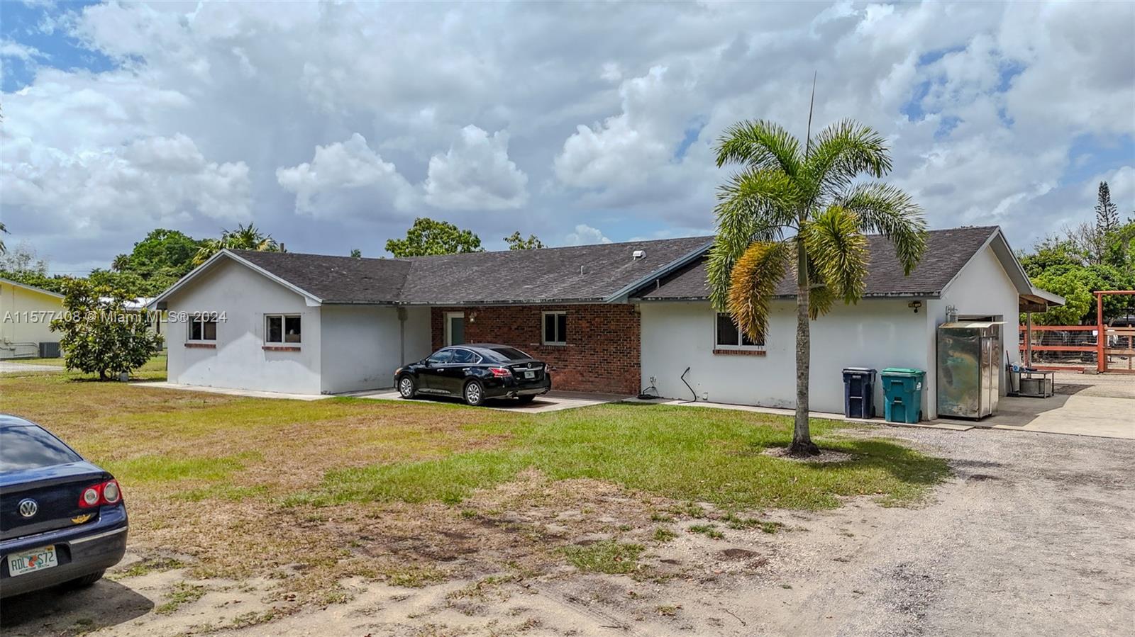 a view of a house with a yard and sitting area