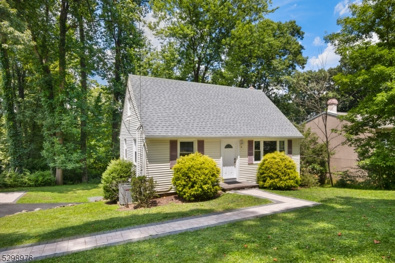 a view of a house with a yard and potted plants