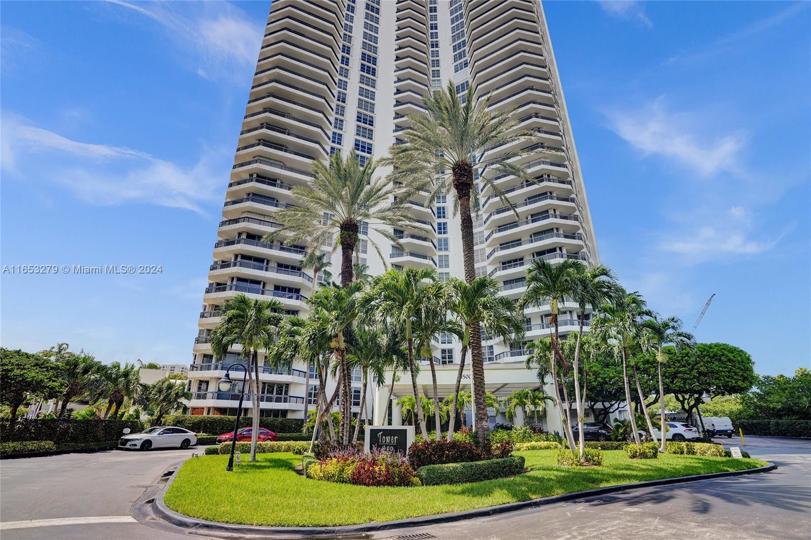 a park with tall buildings and trees in the background