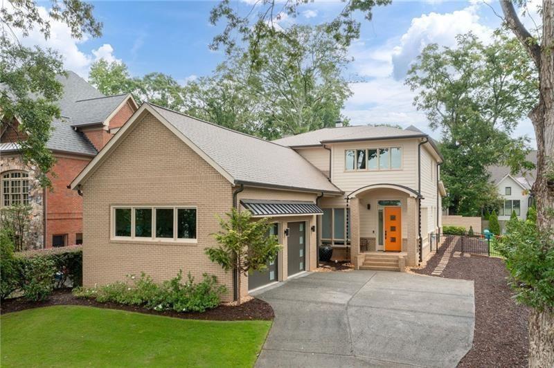 a front view of a house with a garden