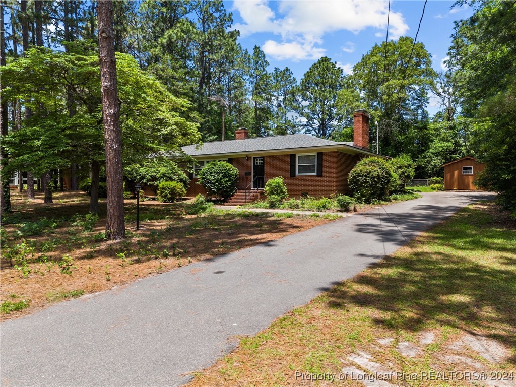 a front view of a house with a yard and a garage