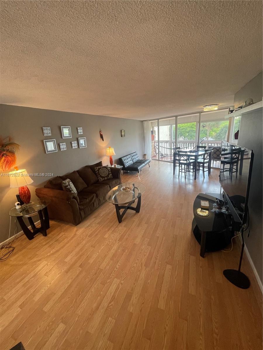 a living room with furniture a window and gym equipment