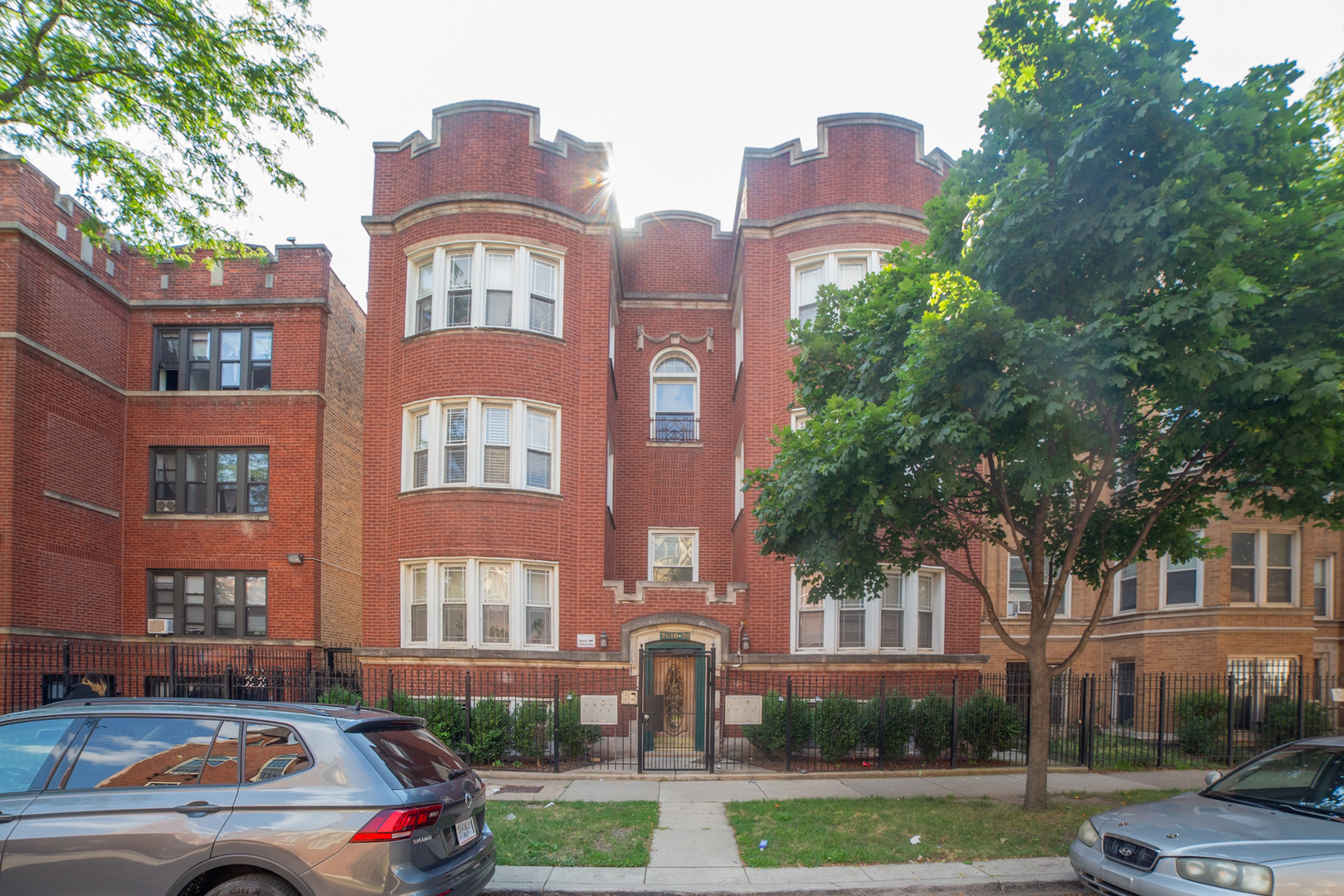 a front view of a residential apartment building with a yard