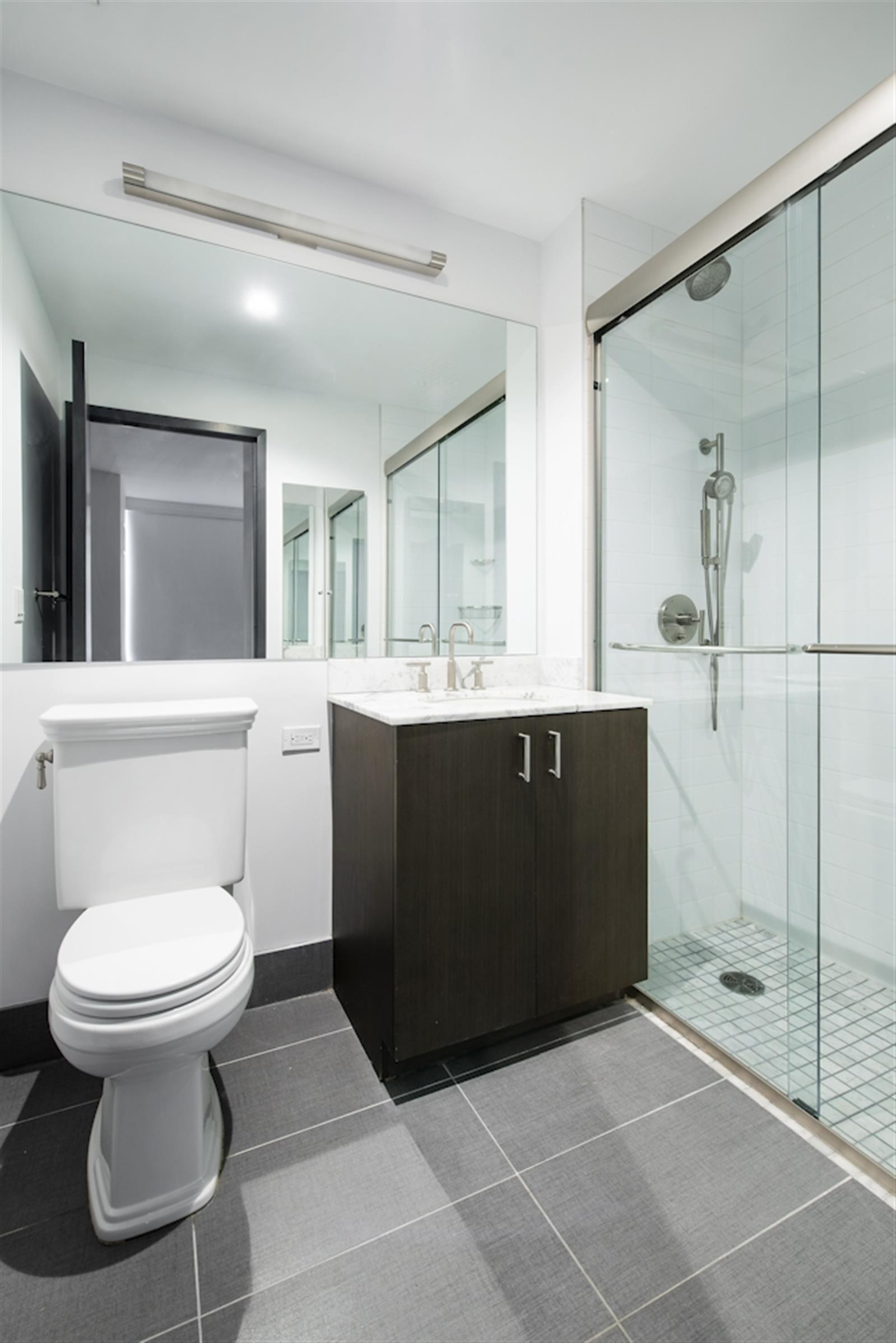 a bathroom with a sink toilet and shower