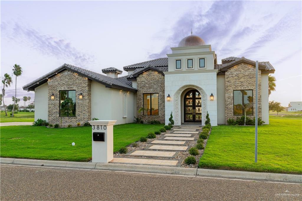 a front view of a house with a garden