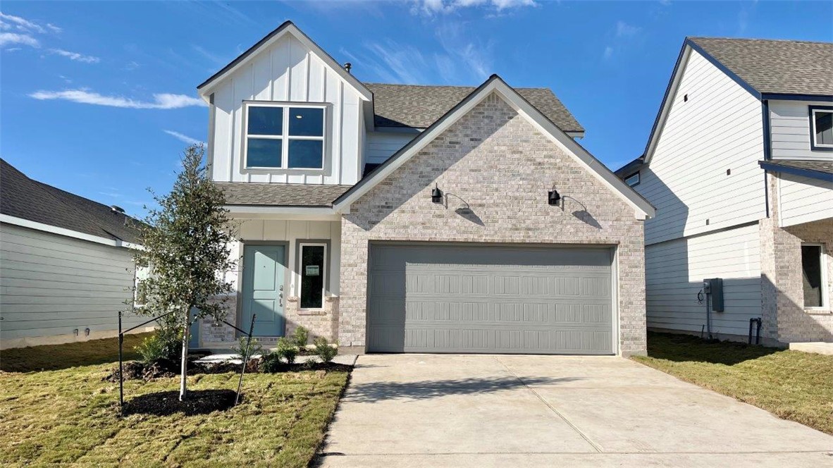 View of front of property with a garage and a fron