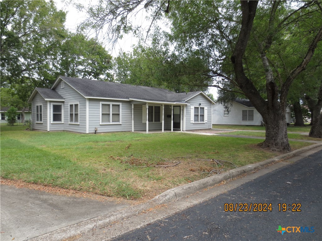 a front view of a house with a garden