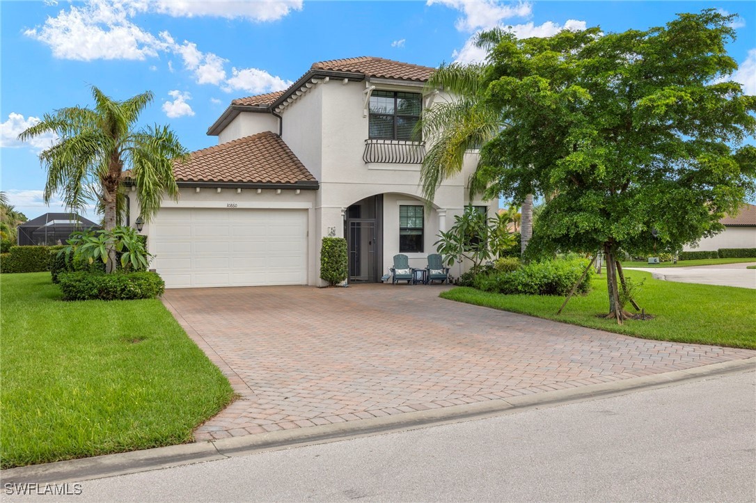 a front view of a house with a yard and garage