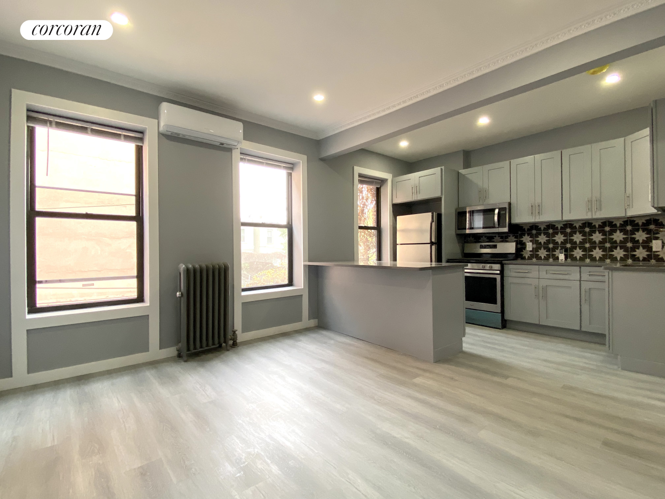 a kitchen with granite countertop white cabinets and stainless steel appliances