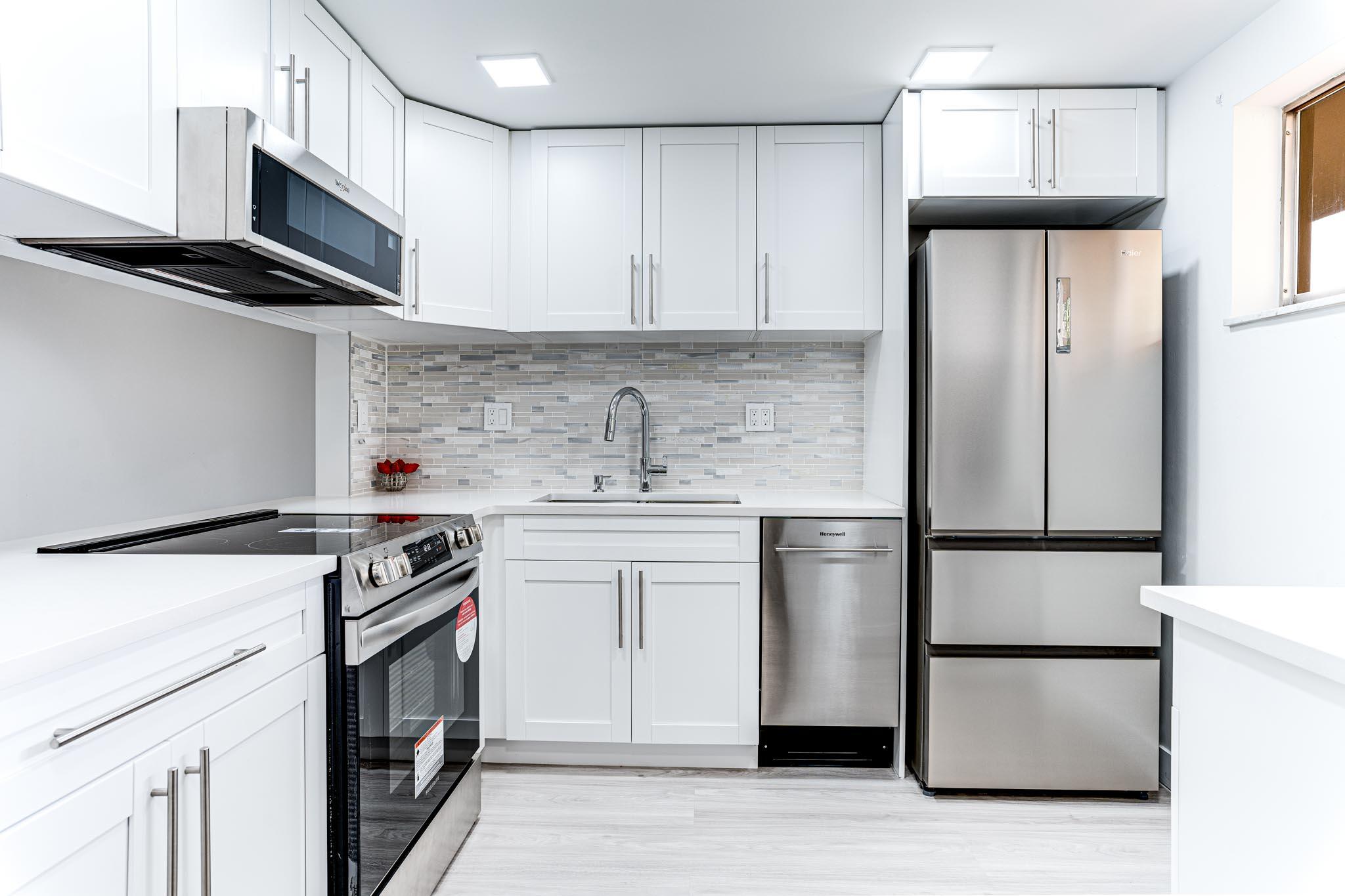 a kitchen with stainless steel appliances a refrigerator stove and microwave