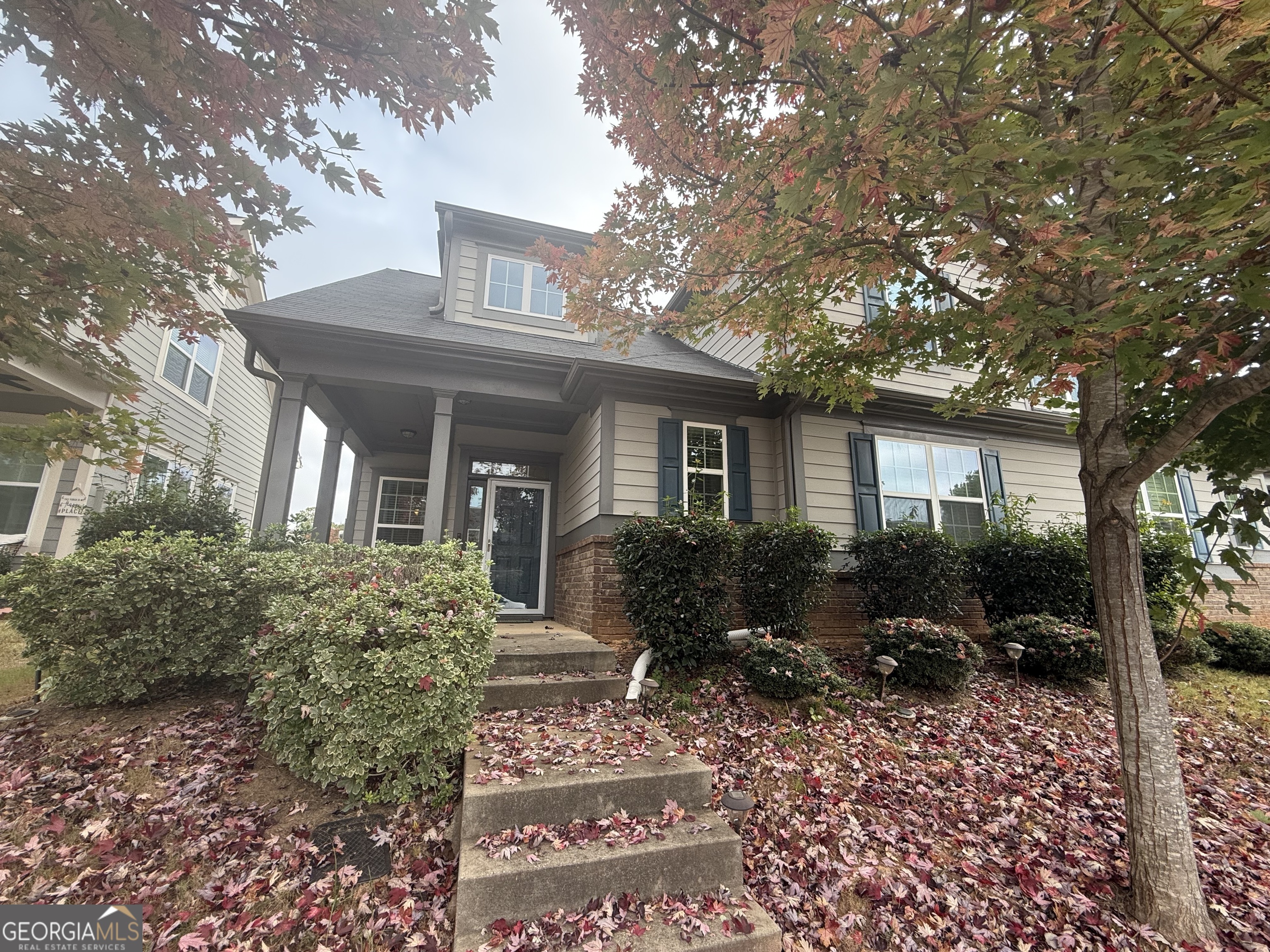 a front view of house with yard and green space