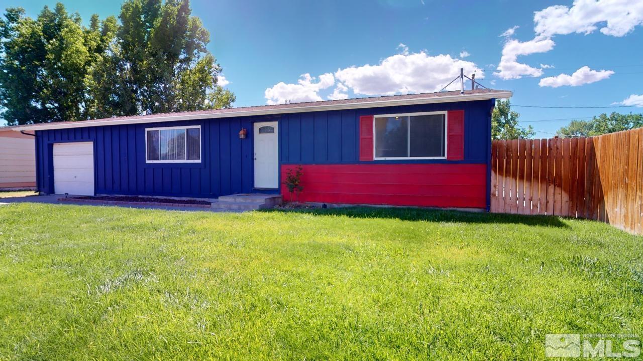 a view of backyard of house with deck and seating space