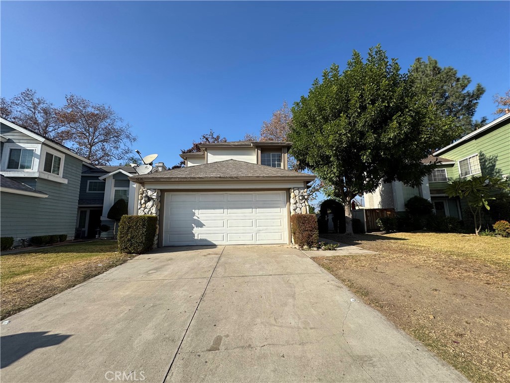 a view of a house with a yard and garage