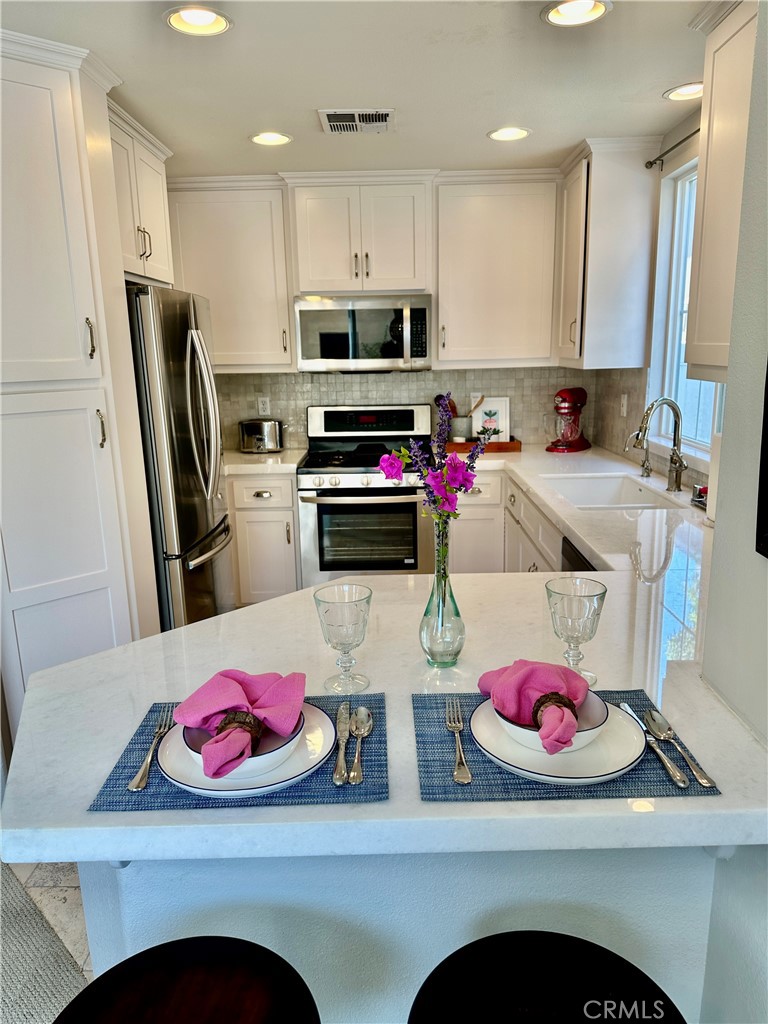 a kitchen with a sink stove and refrigerator