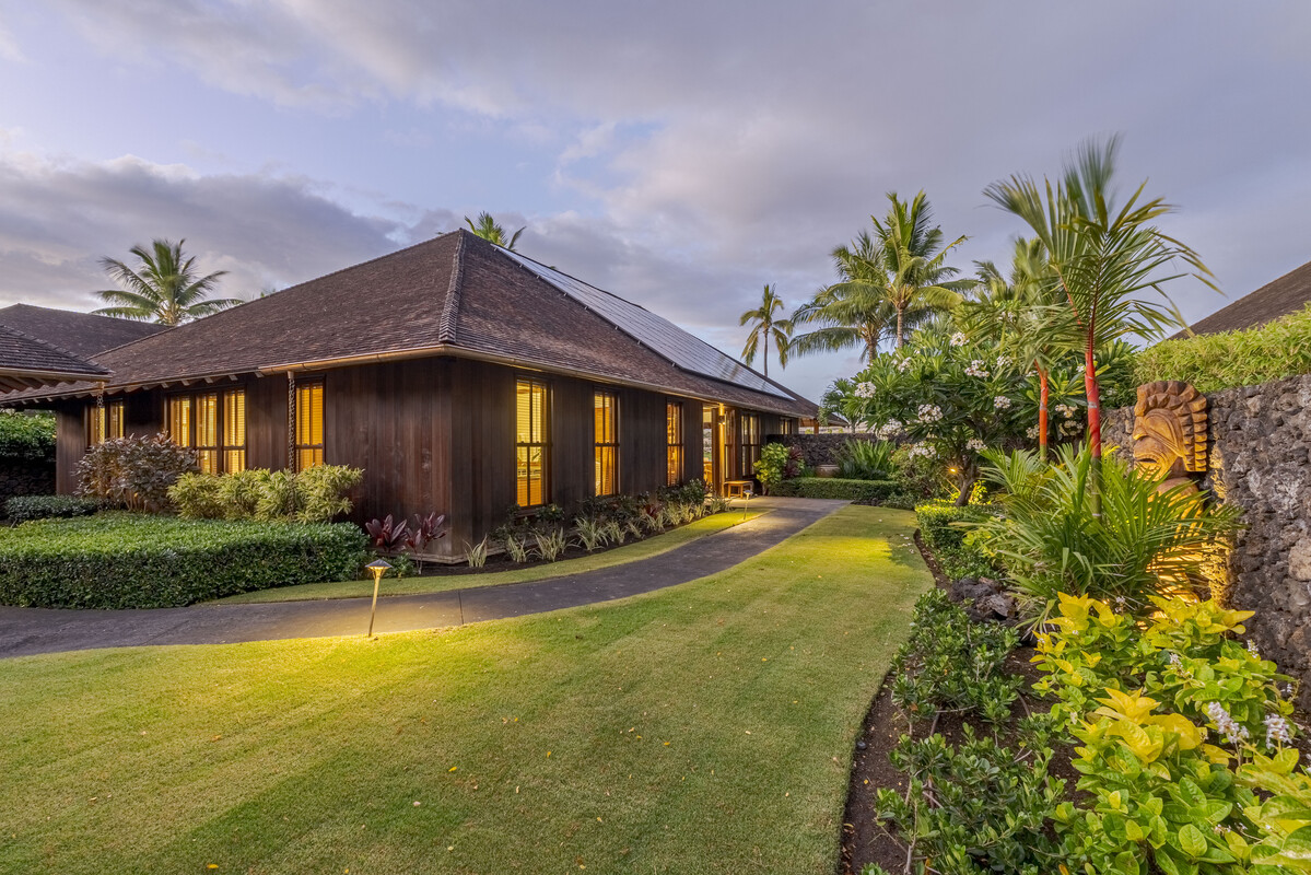 a front view of house with yard and swimming pool