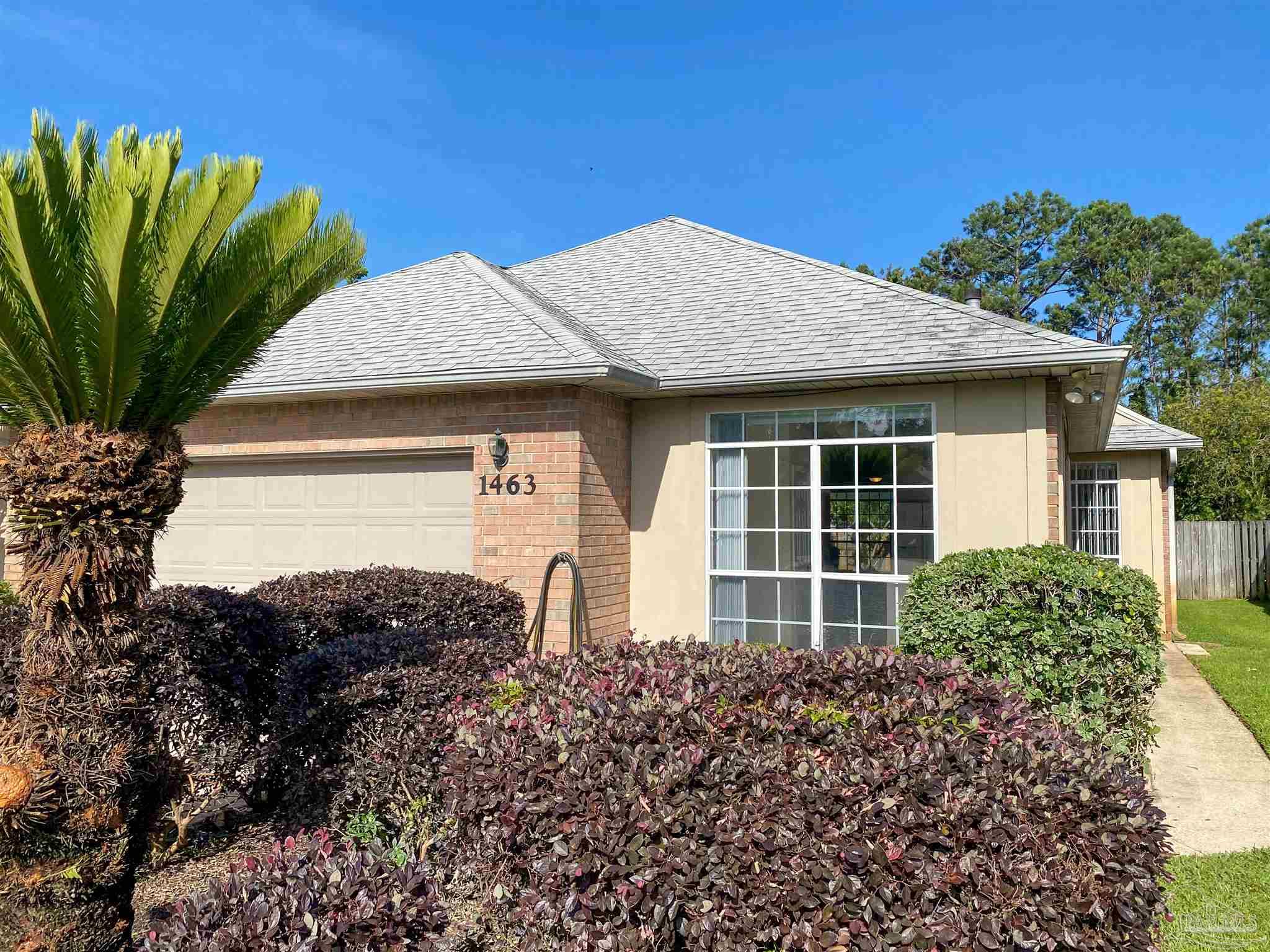 a front view of a house with a garden