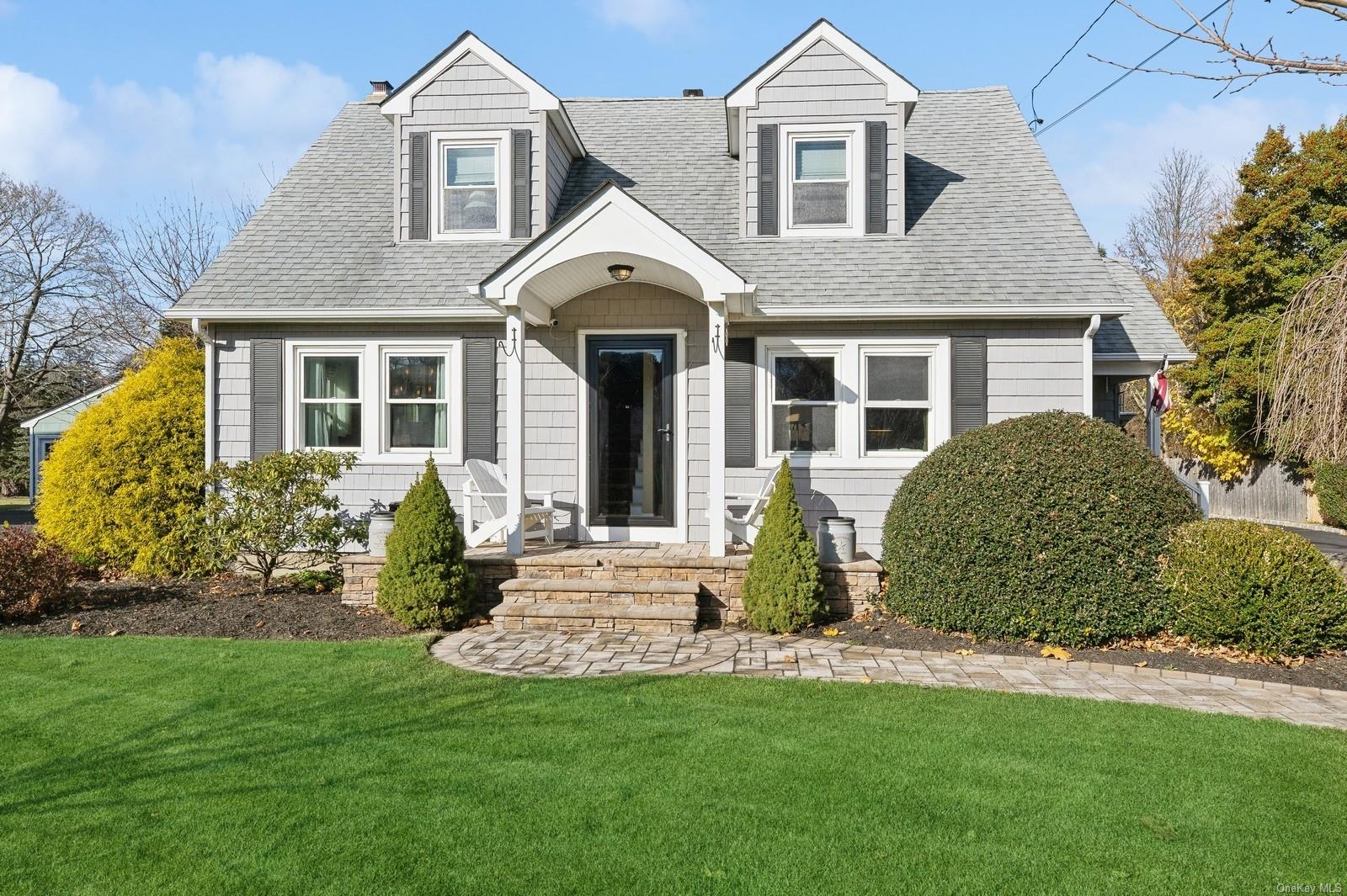 Cape cod home with a front lawn