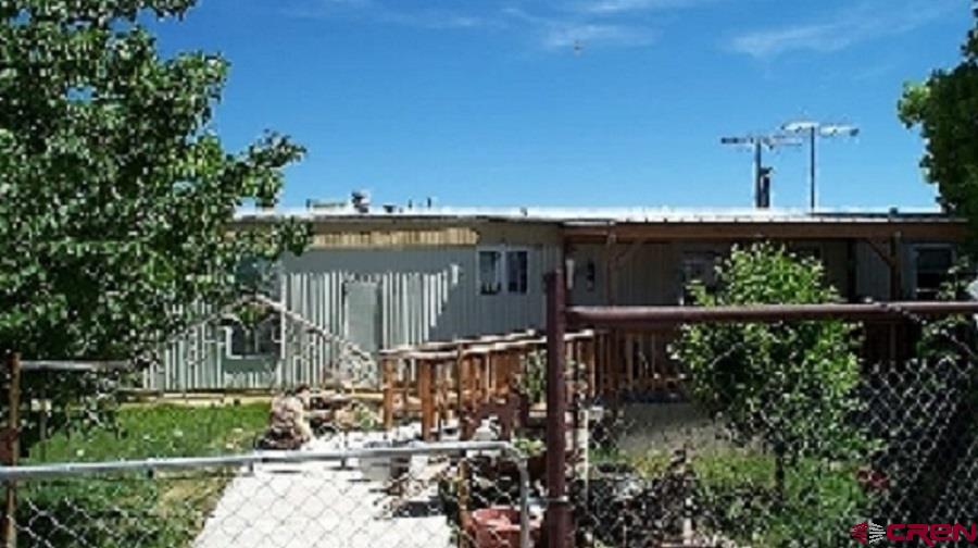 a view of a balcony with yard