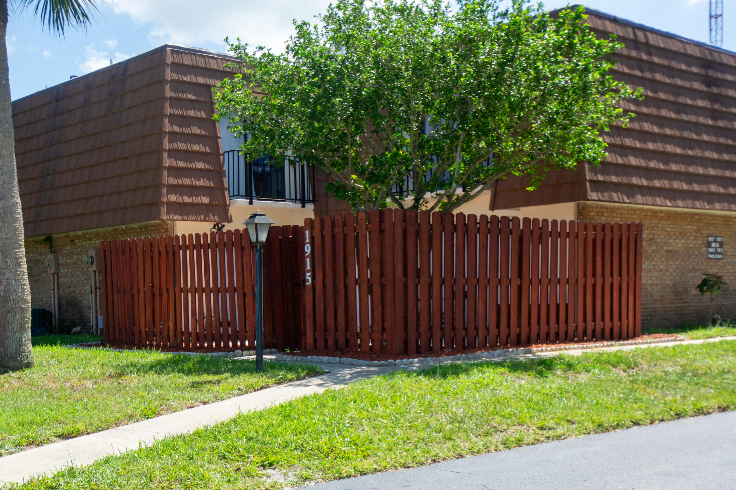 a view of a backyard with wooden fence